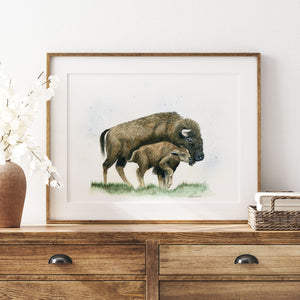 a picture of a bison and her calf on a dresser