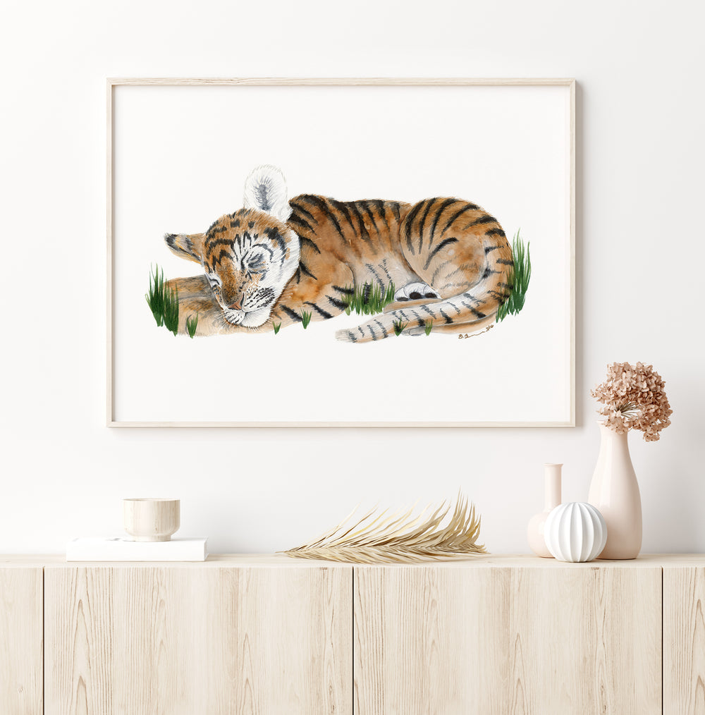 a picture of a tiger laying down in the grass