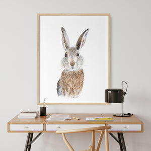 a picture of a rabbit on a wall above a desk