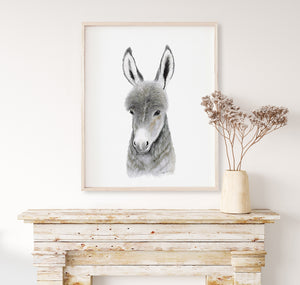 a picture of a donkey in a frame on a mantle