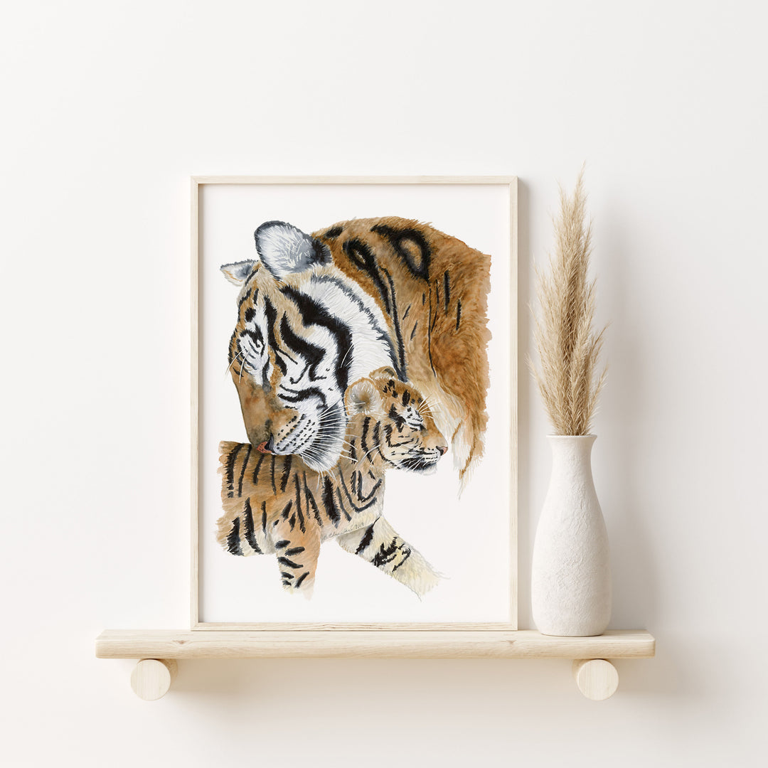 a picture of a tiger and her cub on a shelf
