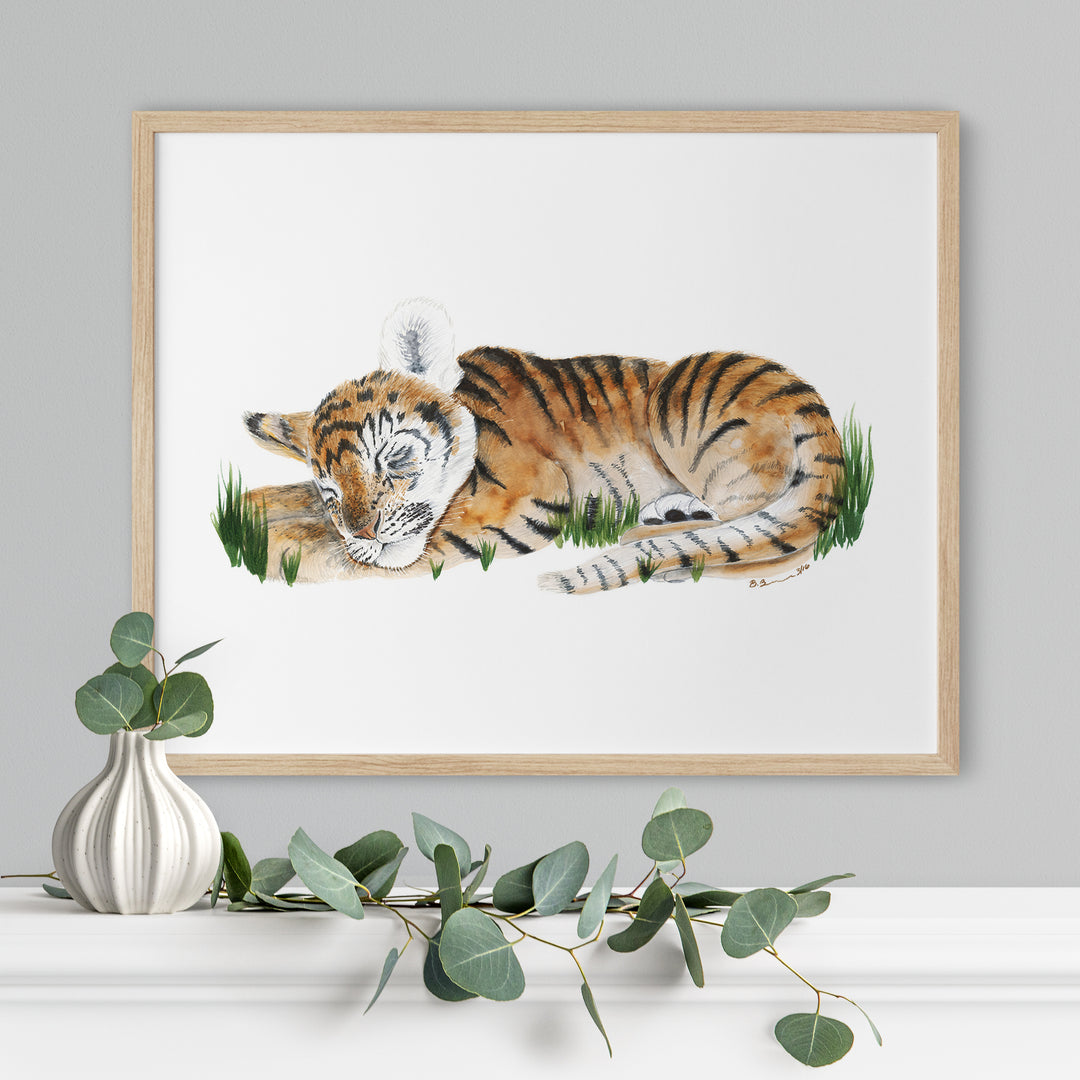 a picture of a tiger laying down in the grass