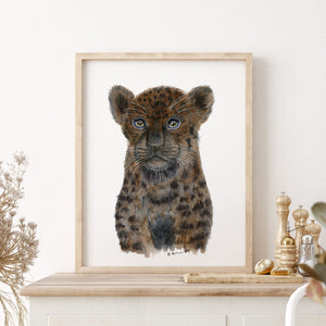 a picture of a baby leopard in a frame
