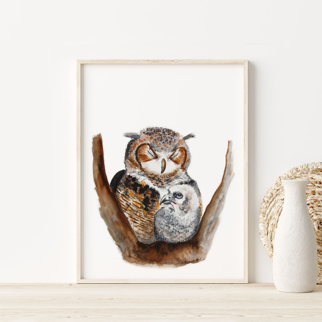 a picture of two owls sitting on a branch