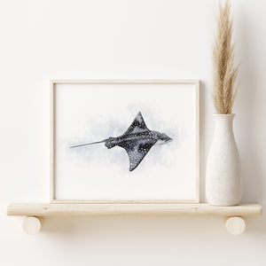 a painting of an eagle ray on a shelf next to a vase