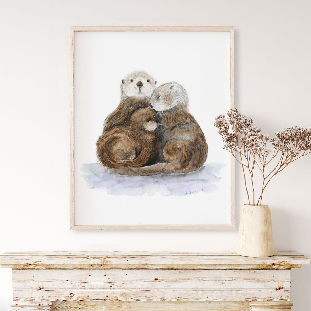 a painting of a family of sea otters cuddling