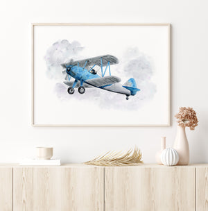 a painting of an airplane on a wall above a dresser