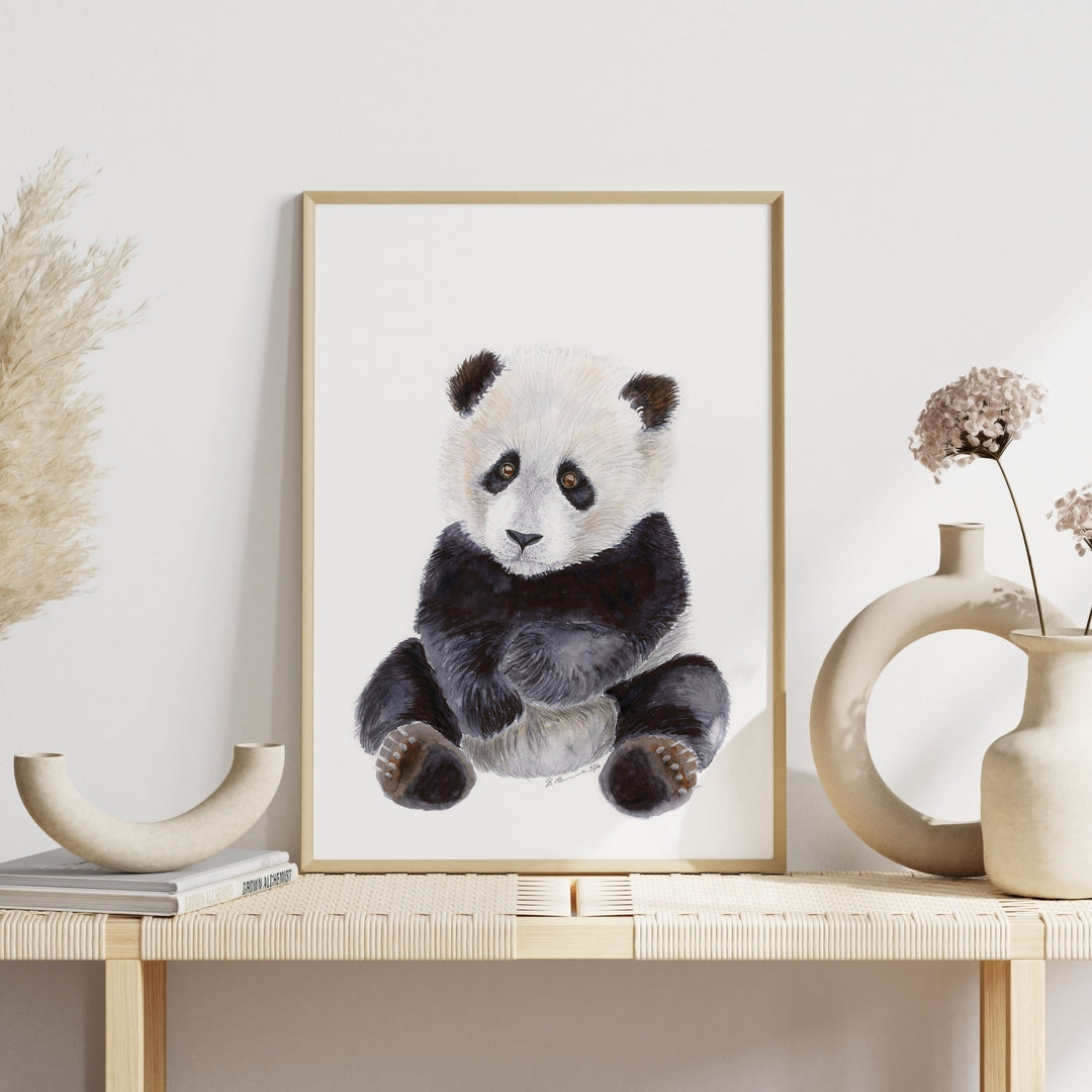 a picture of a panda bear hanging on a wall
