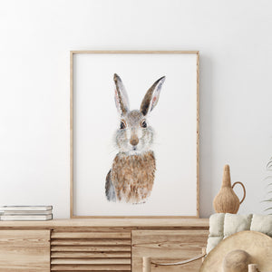 a picture of a rabbit in a frame on a dresser