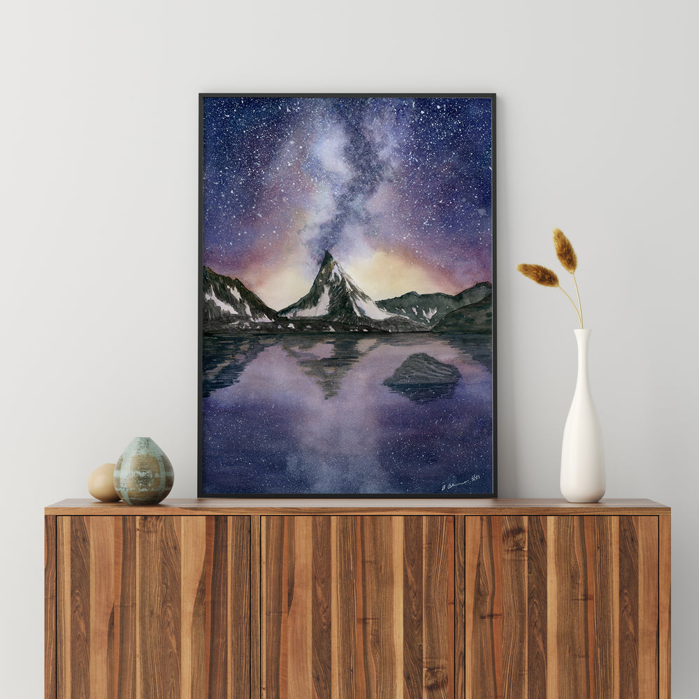 a painting on a wall above a wooden cabinet