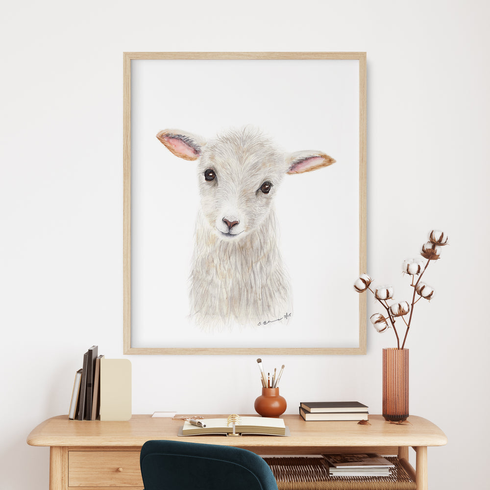 a picture of a sheep is hanging above a desk