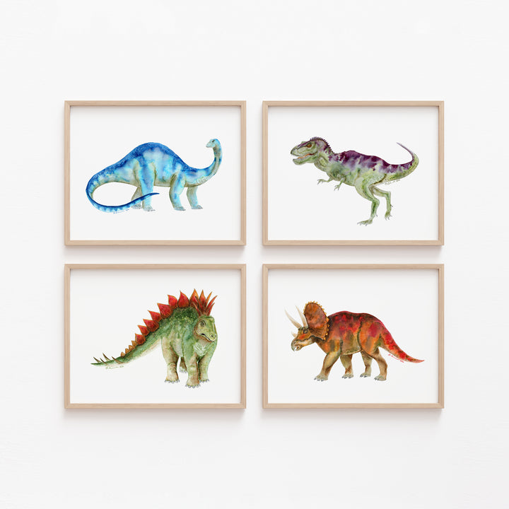Set of 4 dinosaur prints featuring T-Rex, Triceratops, Stegosaurus, and Brontosaurus in light wood frames