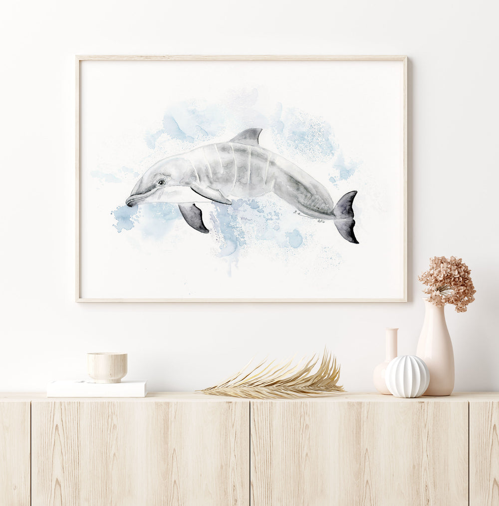 a painting of a dolphin is hanging on a wall