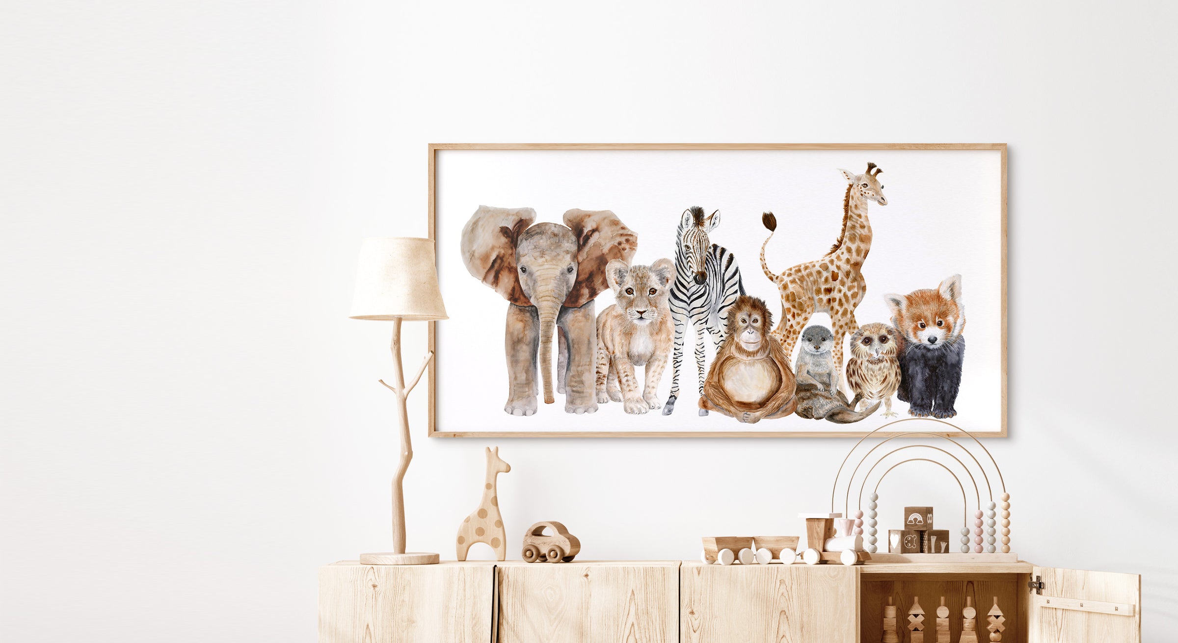 Safari animal watercolor wall art in a child’s room with light wood frame and neutral nursery decor