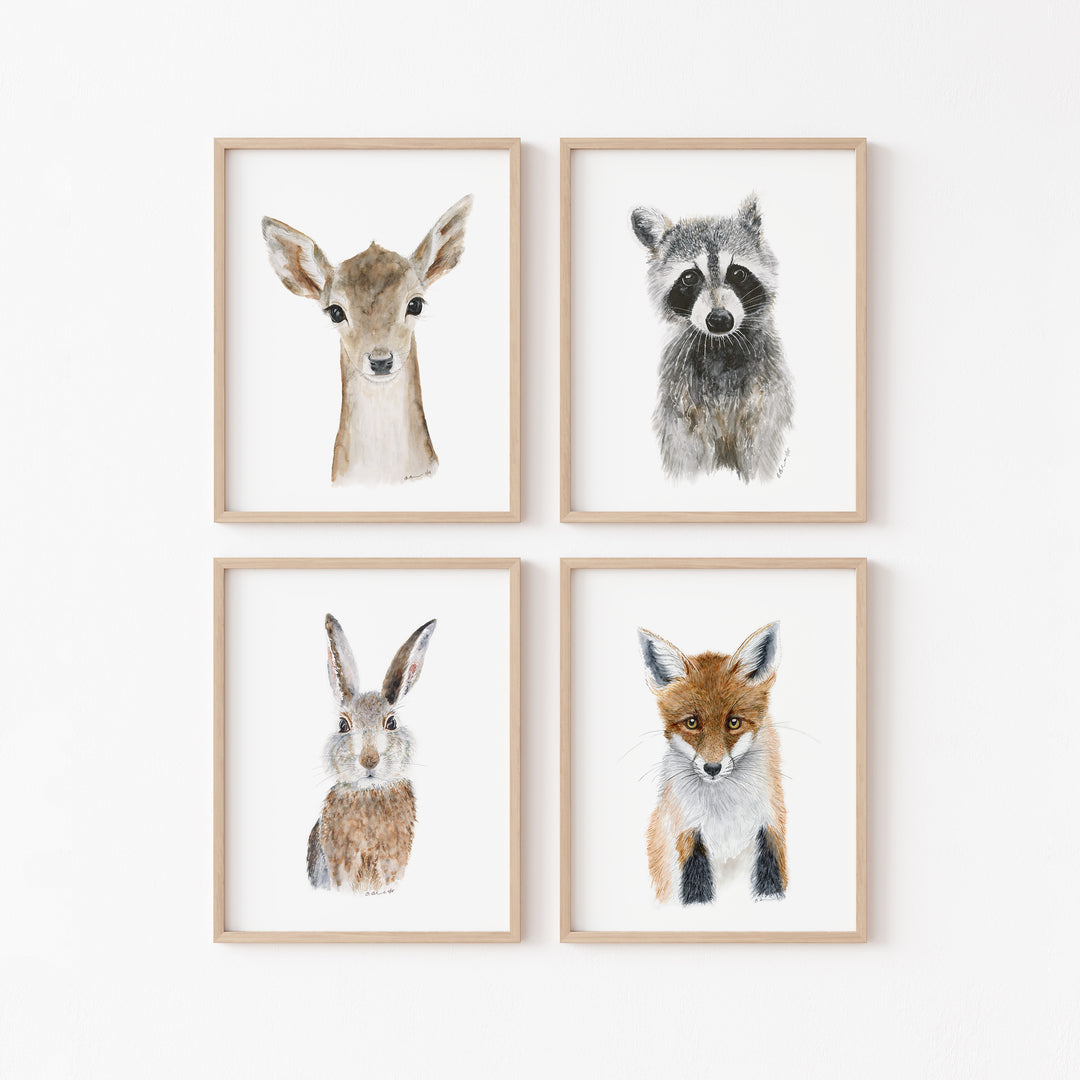 Set of 4 woodland animal prints featuring a fox, deer, raccoon, and rabbit in light wood frames