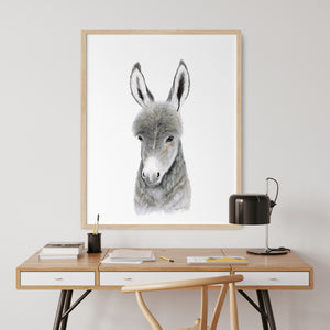 a picture of a donkey on a wall above a desk