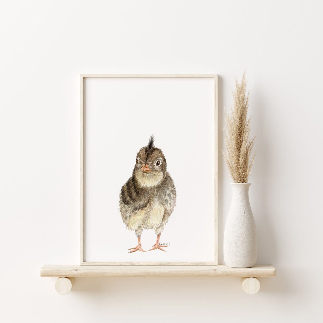 a picture of a quail chick on a shelf next to a vase