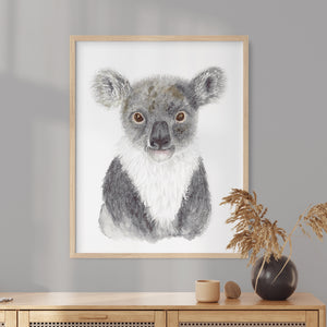 a picture of a koala in a frame on a wall