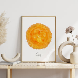 a picture of a yellow sun on a white wall