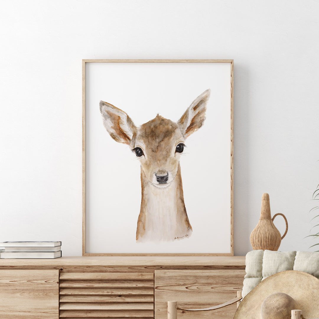 a picture of a deer is hanging on a wall