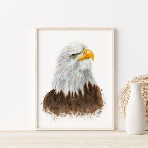 a painting of an eagle in a frame next to a vase