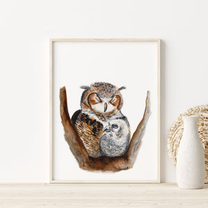 a picture of two owls sitting on a branch