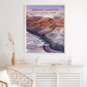 a poster of a grand canyon national park hangs on a wall