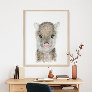a picture of a baby animal on a wall above a desk