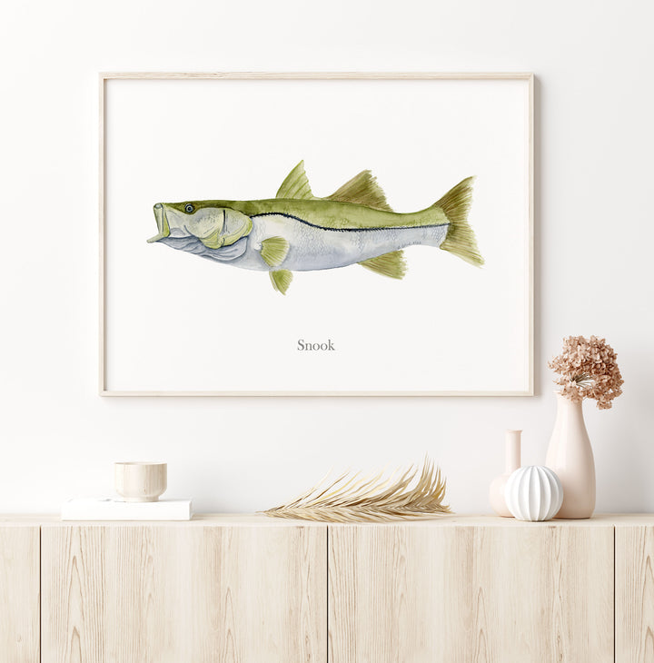 a painting of a snook on a white wall