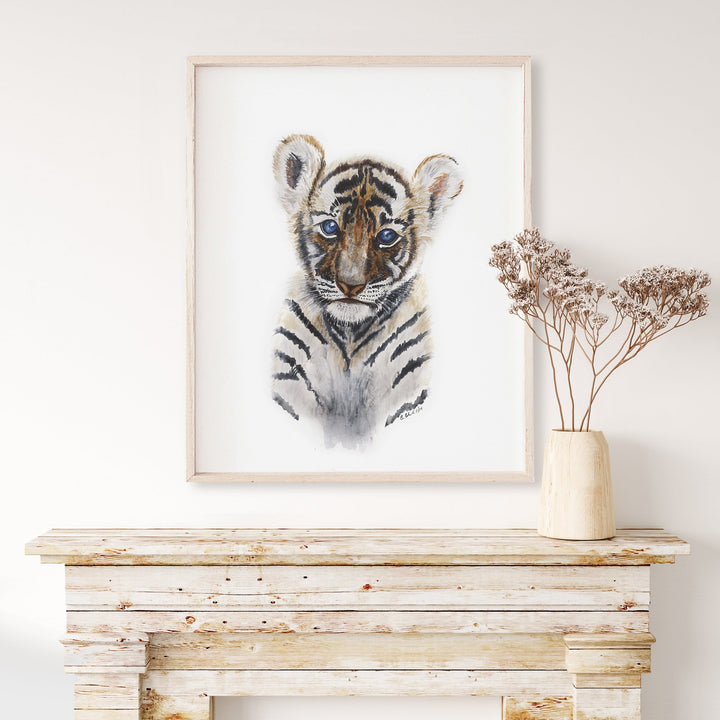 a picture of a tiger in a frame on a mantle