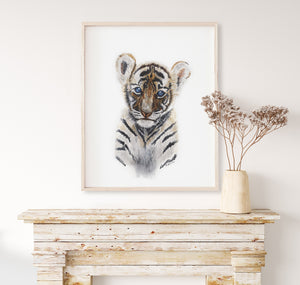 a picture of a tiger in a frame on a mantle