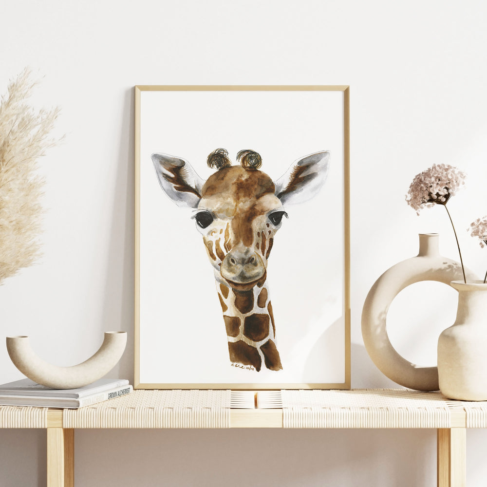 giraffe nursery artwork on table in safari themed baby room