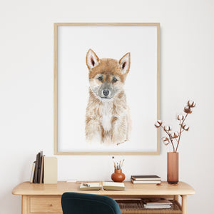 a picture of a dog on a wall above a desk