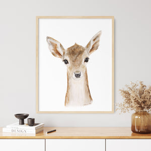 a picture of a deer is hanging on a wall