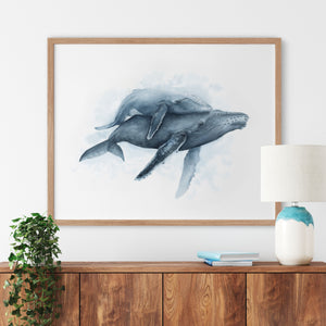 a watercolor of mother humpback whale and her calf on a wall above a dresser