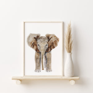 a picture of an baby elephant on a shelf next to a vase